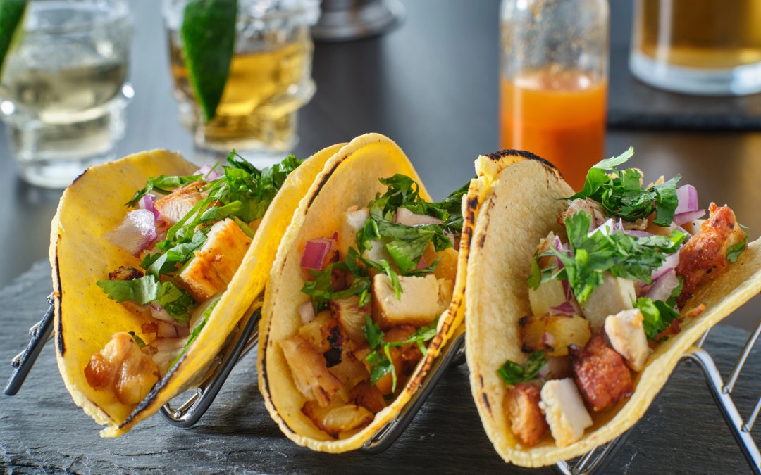 Tasty grilled pineapple and chicken street tacos in metal tray